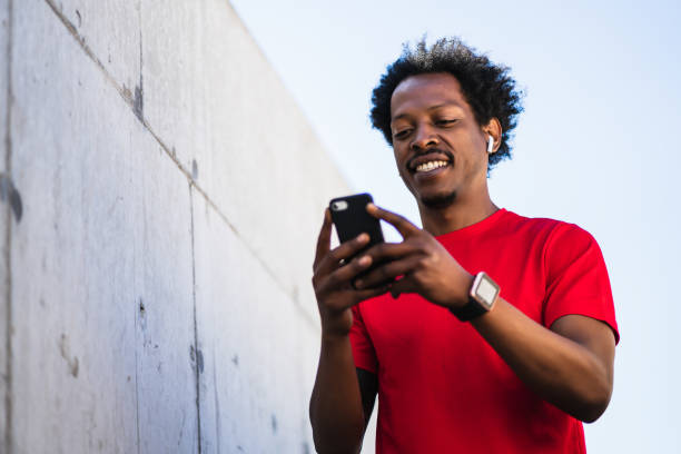 istock Athlete man using his mobile phone outdoors. 1317623706