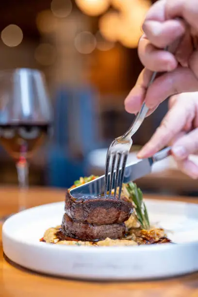 Cutting Filet Mignon at a restaurant