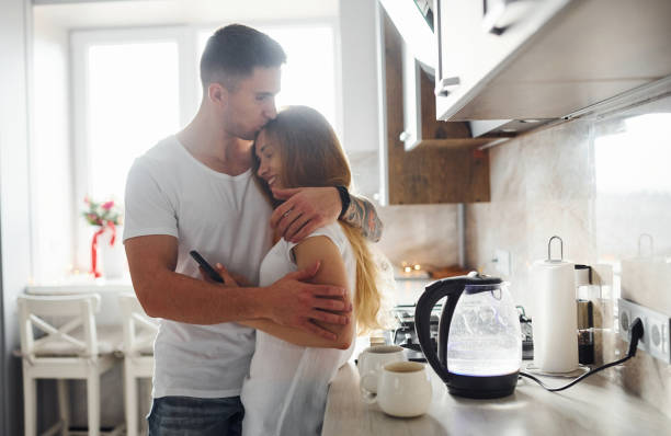 istock Young couple at morning together standing on the modern kitchen 1317625041