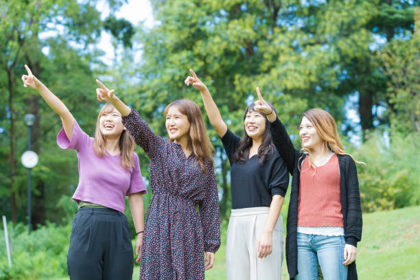 istock 4 asian girls in the park 1317625237
