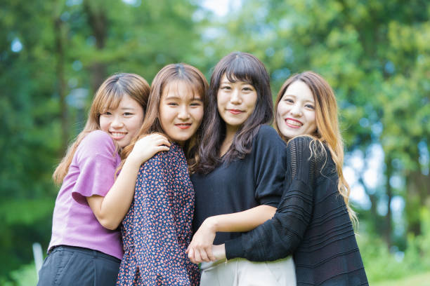 istock 4 asian girls in the park 1317626263