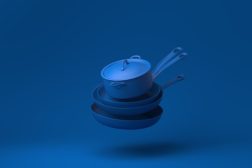 Blue Flying pan and Kitchen pot floating in blue background. minimal concept idea creative. monochrome. 3D render.