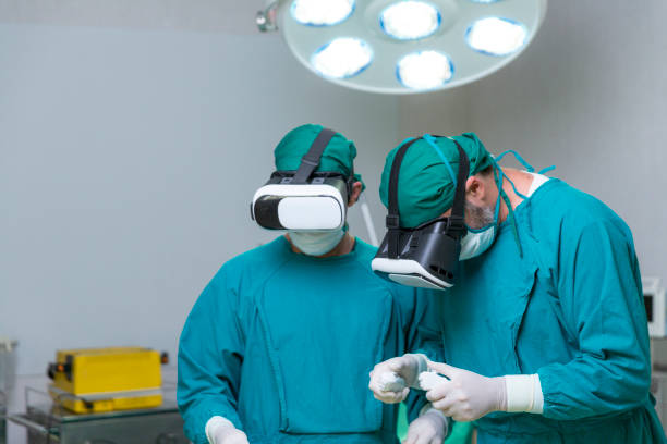 Doctor surgeon wearing virtual reality glasses. The surgeon is doing surgery by inserting a camera and using a virtual reality controller. stock photo