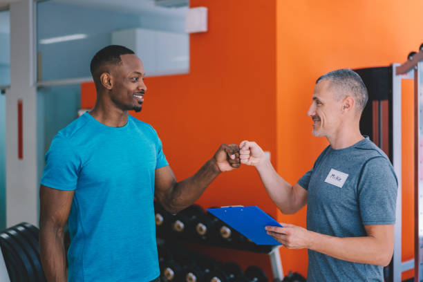 istock Sports training in the gym with personal trainer 1317630132