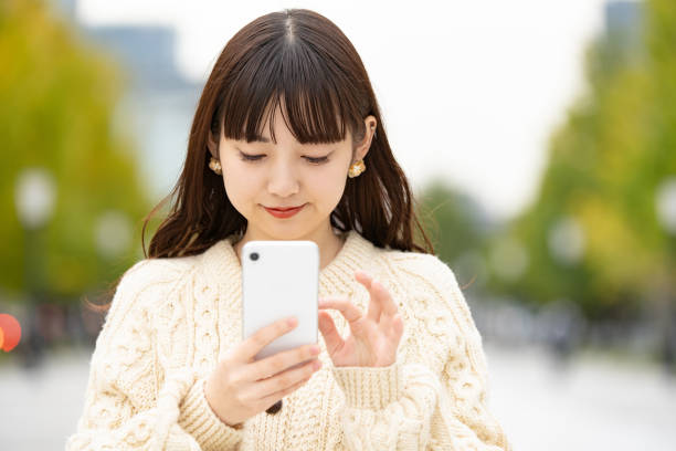 istock asian young woman using smartphone 1317631103