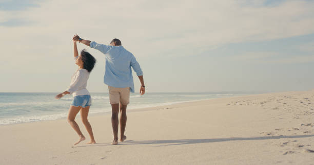 istock Shot of an affectionate couple walking on the beach 1317632780