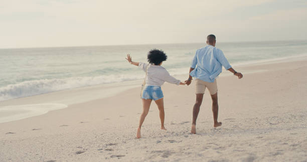 istock Shot of an affectionate couple walking on the beach 1317632782