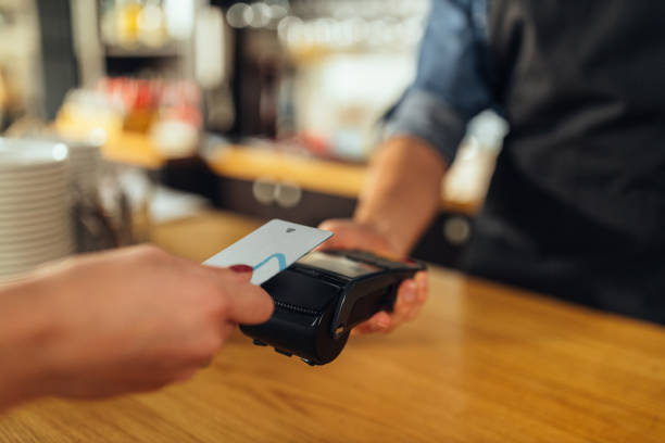 istock Customer paying for coffee with a credit card at a cafe 1317633278