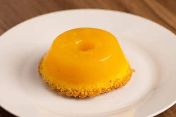Brazilian quindim is a sweet made from egg yolk, sugar and grated coconut. Corresponds to the Portuguese recipe known as brisa-do-Lis, using grated coconut or almond.Brazilian dessert. Background with