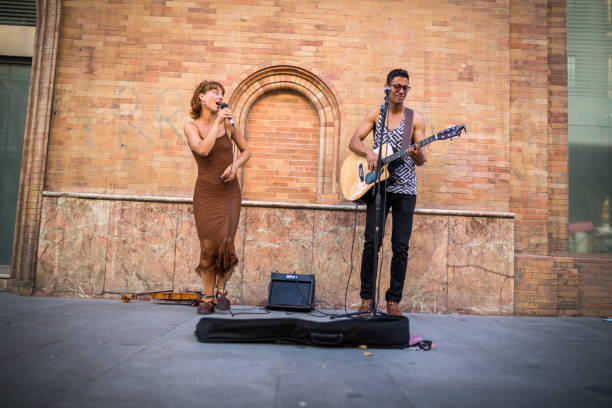 스페인 세비야의 바쁜 거리에서 노는 버스커. 기타리스트 남자와 가수 여자. - street musician 뉴스 사진 이미지