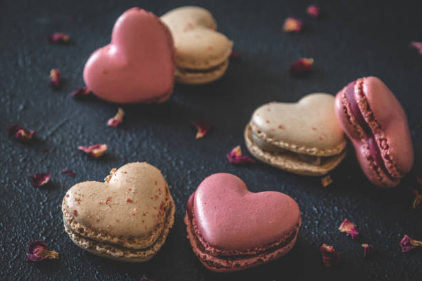 istock Heart shaped macarons on dark blue background 1317634959