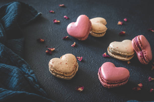 istock Heart shaped macarons on dark blue background 1317635857