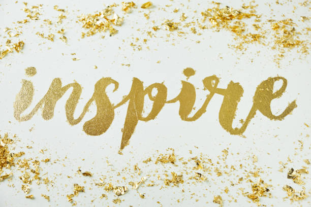 istock Inspire. Motivating lettering on white board. Handmade creativity. Gold letters. Gilding. 1317636883