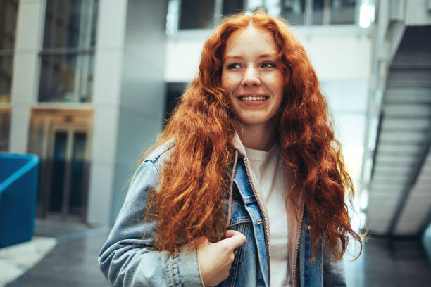istock Smiling female student in college campus 1317636974