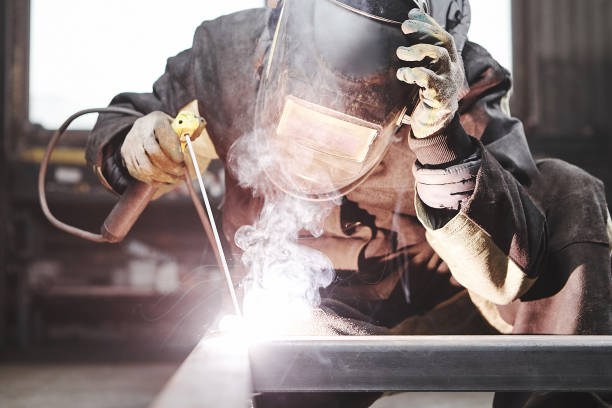 istock Man in protective mask welding metal construction. 1317637322