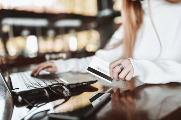 istock Female Using Laptop And Paying With Credit Card In Restaurant 1317637617