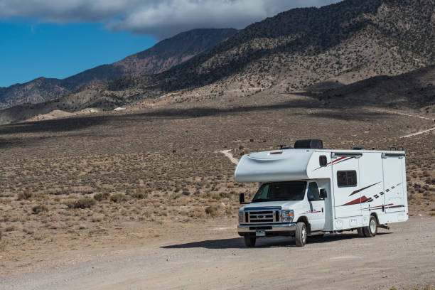 istock C-type camper with slideouts standing in the desert with mountains in the background 1317638384