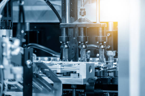 istock The preform shape of PET bottle in the blowing mold machine. 1317638668
