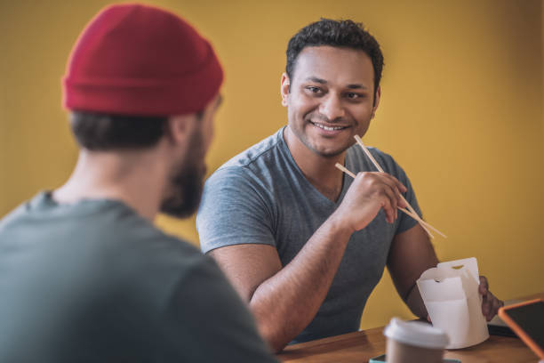 istock Colleagues having lunch and talking in the kitchen 1317638871