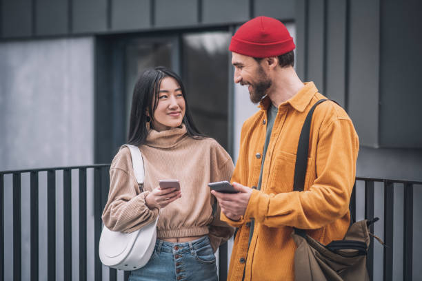 istock Young couple with smartphones in their hands 1317639199