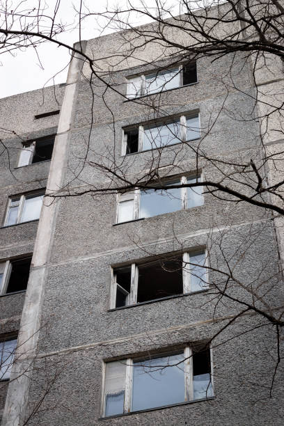 istock Old destroyed abandoned high rise building with broken windows in ghost town Pripyat, Chernobyl Exclusion Zone, Ukraine. Vertical photo 1317639321