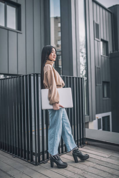 istock An asian young woman with a laptop 1317639403