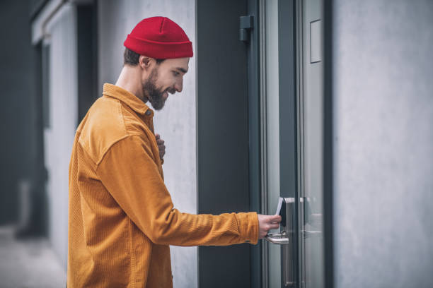 istock Bearded young man opening the door with an access card 1317640091