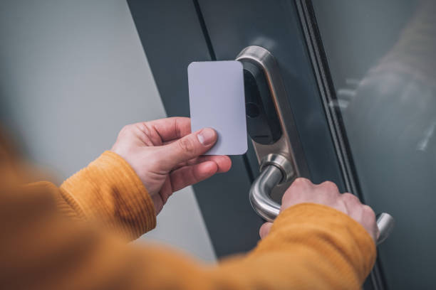 istock Bearded young man opening the door with an access card 1317640094