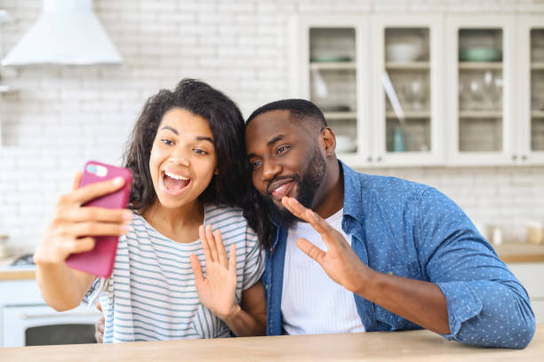 istock Cheerful couple talking via phone camera 1317640349