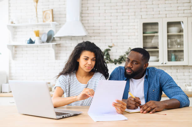 istock Young multiracial family discussing their budget 1317640699