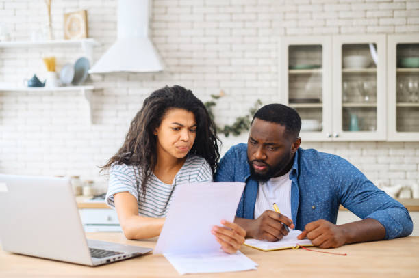 istock Young multiracial family discussing their budget 1317640756