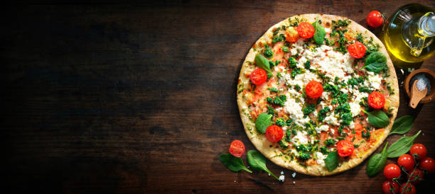 istock Crispy spinach pizza with ricotta, mozzarella and tomatoes 1317641079