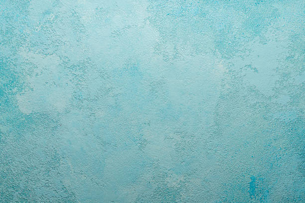 istock Beautiful abstract grunge decorative light blue cyan painted stucco wall texture. Handmade rough paper white background with copy space, green shade 1317641835
