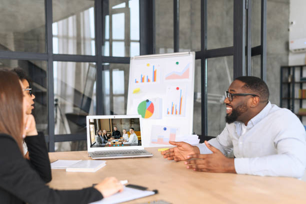 istock Diverse employees talking with work team via video call on the laptop 1317642024
