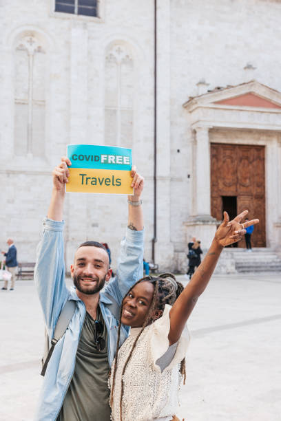 istock Covid-FREE Travels celebration! Young coupl posing in a town square on vacation 1317643281