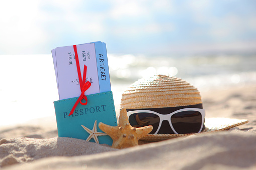Plane tickets and passport on the beach near the sea close up. High quality FullHD footage