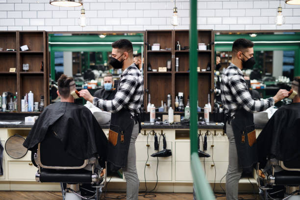 istock Man client visiting haidresser in barber shop, coronavirus and new normal concept. 1317647455