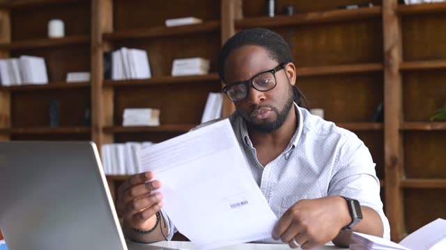 Focused African-American guy holds a letter