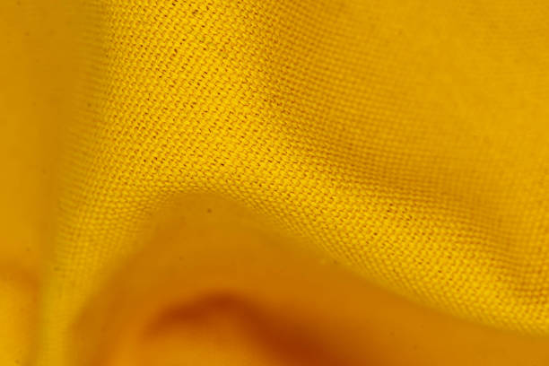 istock A wave of yellow fabric textiles bacground 1317649097