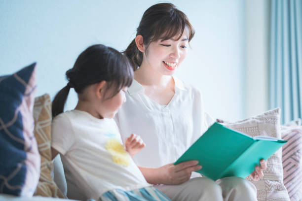 istock Mother and daughter reading a picture book 1317650186