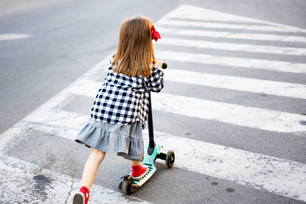 istock Girl riding push scooter 1317650213