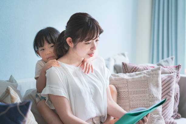 istock Mother and daughter reading a picture book 1317650257
