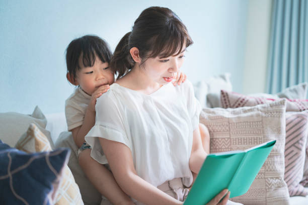 istock Mother and daughter reading a picture book 1317650699
