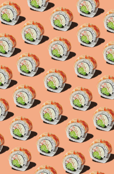 Pattern of rolls with prawn fillet on pinkish orange background Pattern of rolls with prawn fillet on pinkish orange background in Ukrainka, Kyiv Oblast, Ukraine cheese texture seamless stock pictures, royalty-free photos & images
