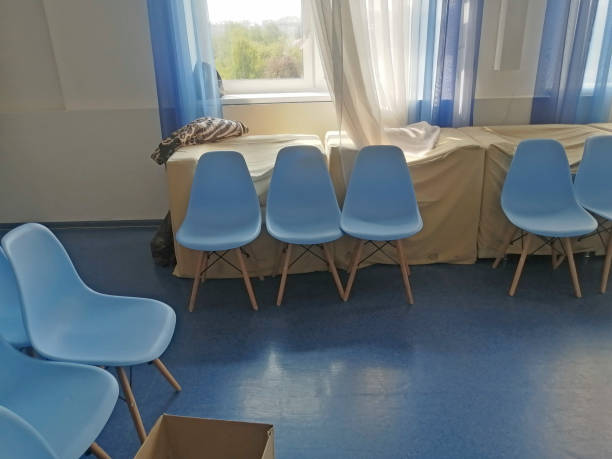 istock Blue seats in a large hall against a wall with boards 1317653900