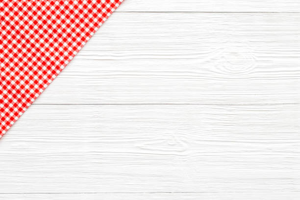 istock Red picnic cloth on wooden table, top view 1317654088