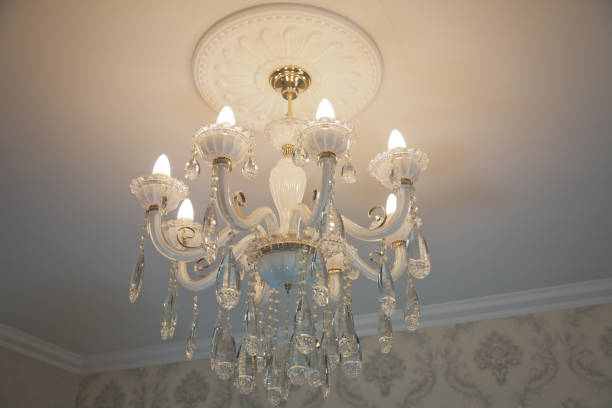 istock A noble candelabrum with many small pearls hangs on the ceiling. A premium decoration for a palace gala, a business meeting in a villa or a wedding . Luxurious interior chandelier with candles. 1317655279