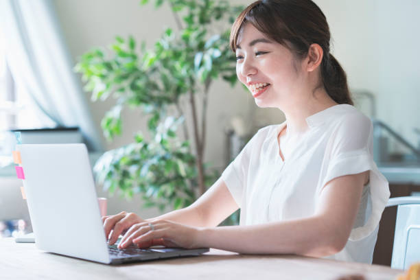 istock Asian woman doing remote work with laptop 1317655997