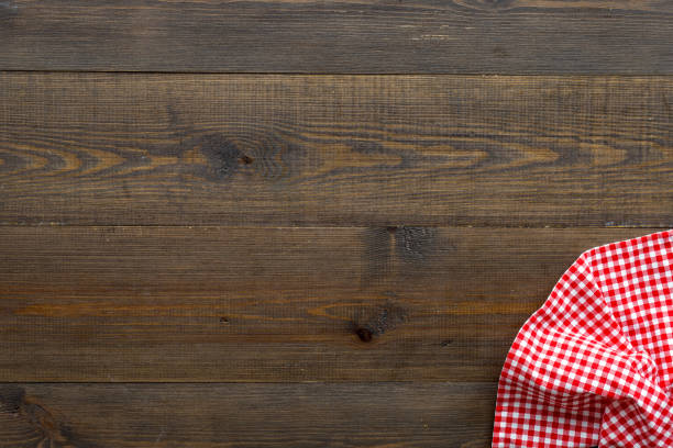 istock Red picnic cloth on wooden table, top view 1317657118