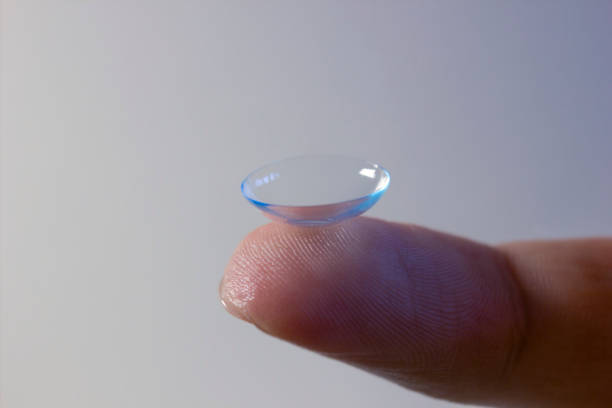 istock Disposable Contact lens on finger on white background, Extreme closeup macro shot. Selective focus of a eye correction lens 1317657269